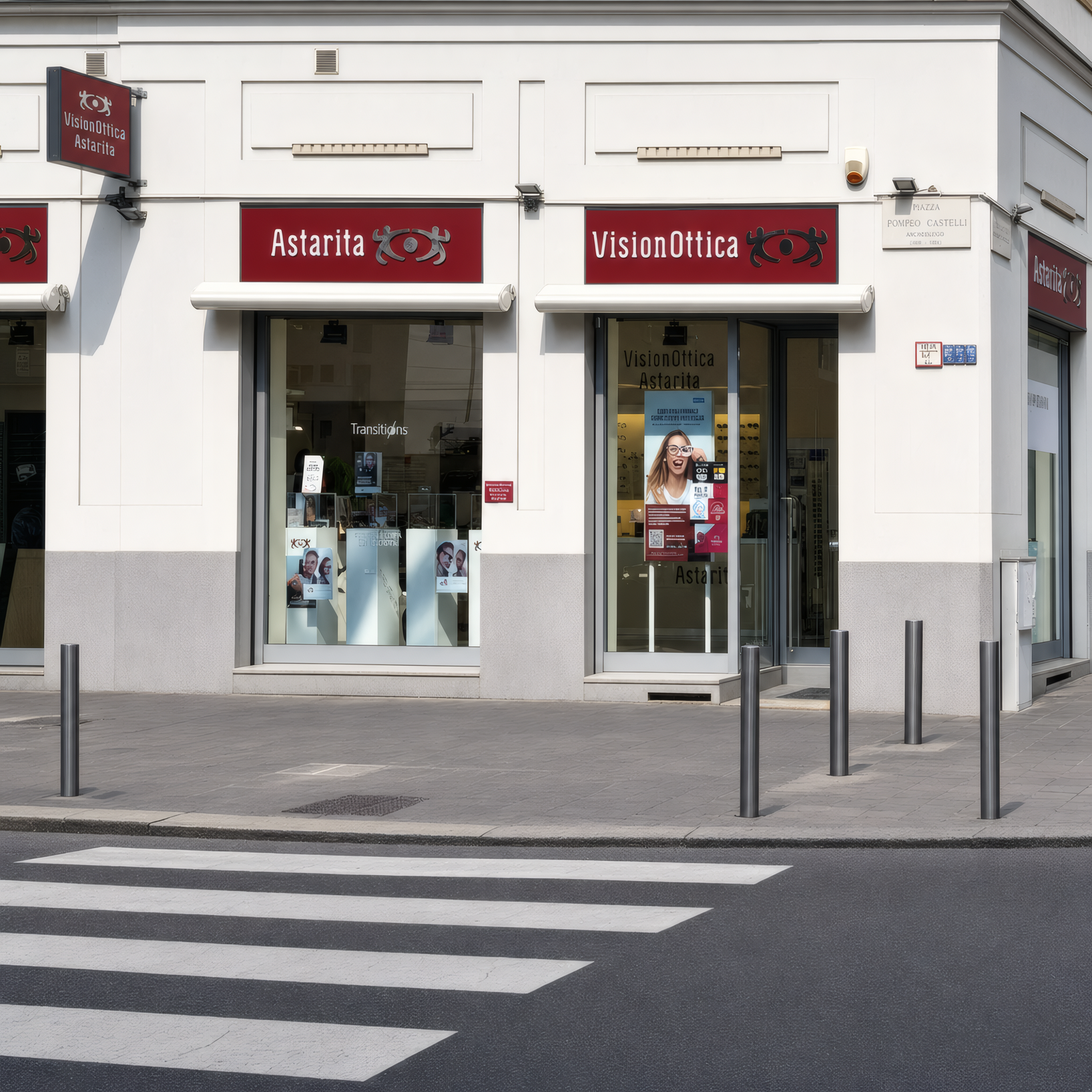 Facciata del negozio VisionOttica Astarita di Milano su via pedonale con insegna bordeaux, vetrina con espositori e tavolini da bar adiacenti